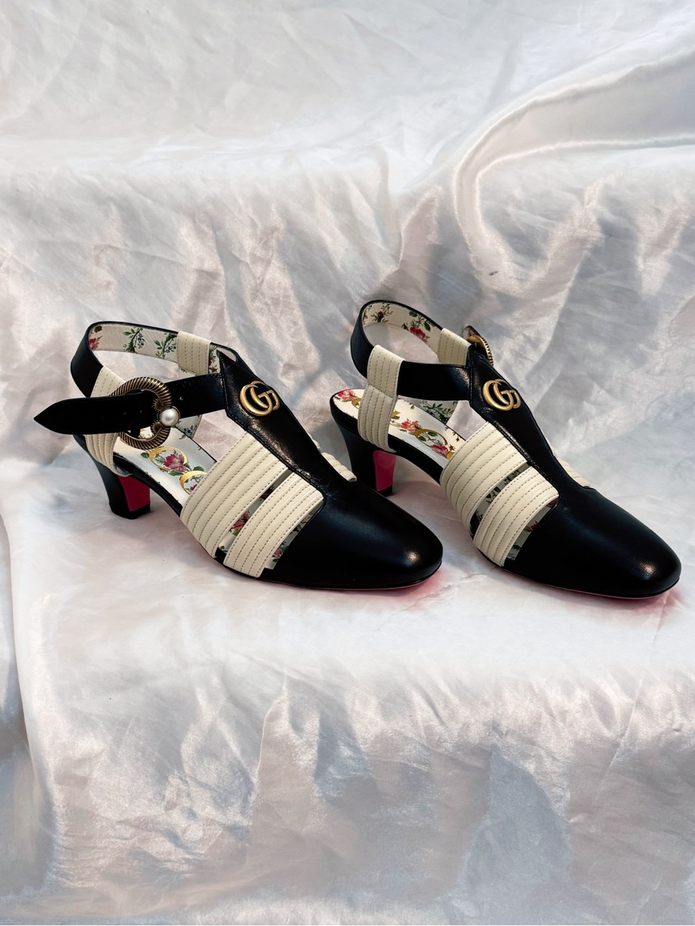 Gucci T-strap pumps featuring signature Double G logo and heart-shaped buckles